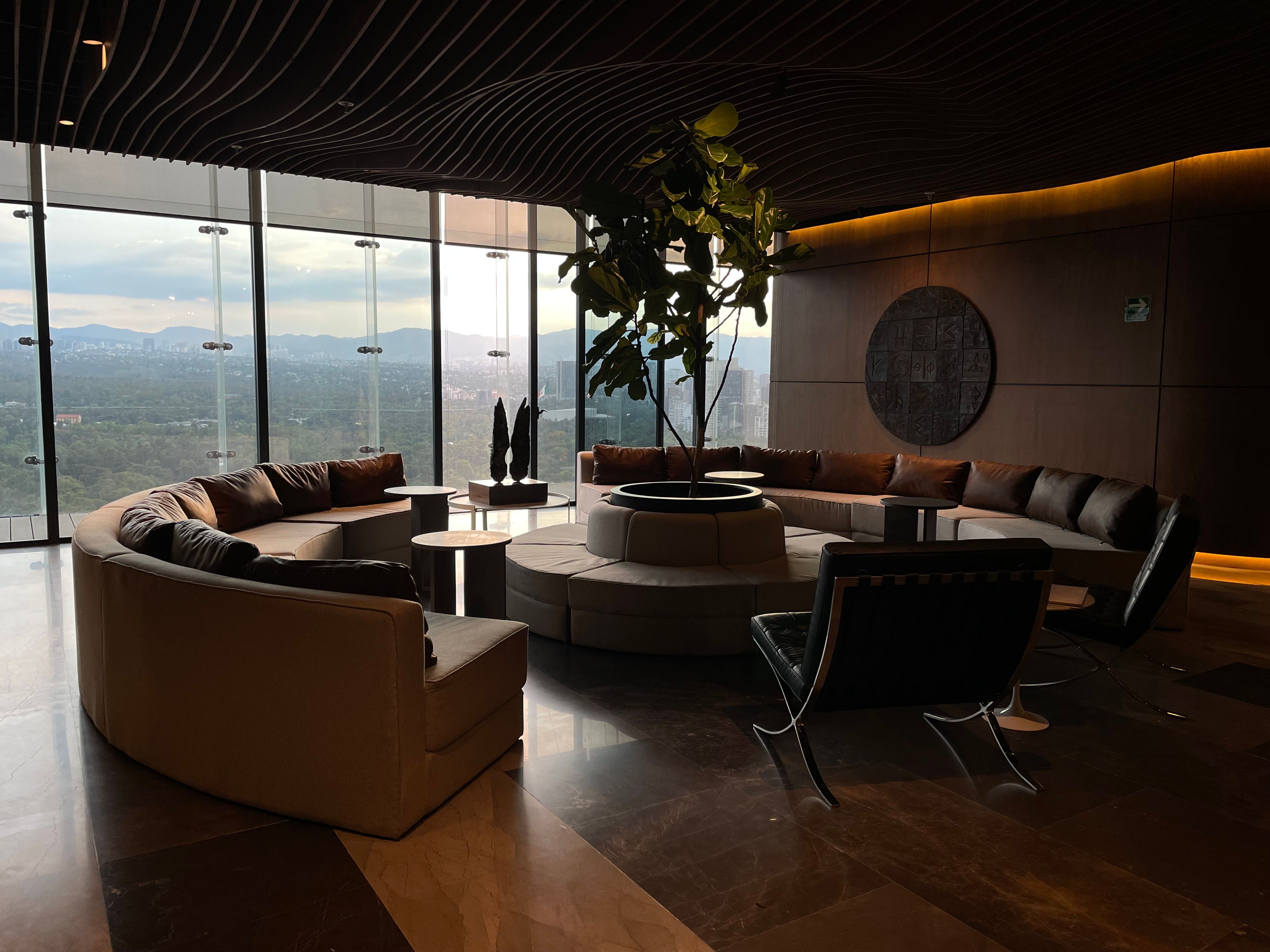 Corporate lounge overlooking a city skyline at dusk